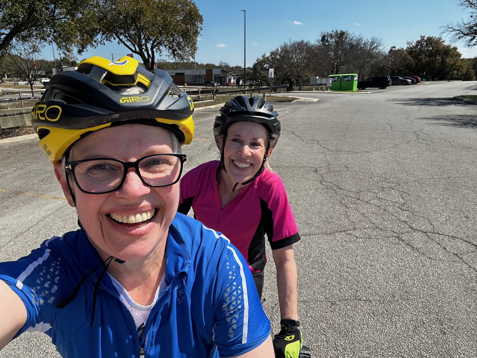 Maggie and Eliza grinning together on bikes on their very first tandem ride